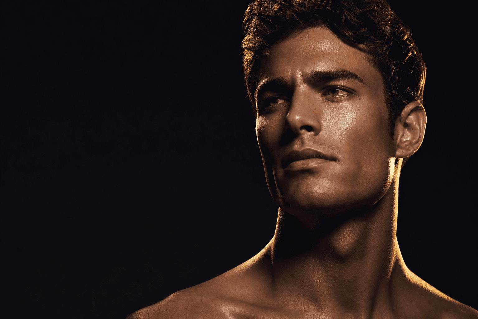 Man with clear, healthy skin in dramatic studio lighting